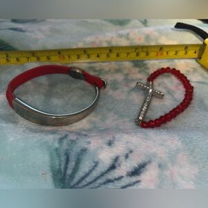 2 Bracelets, 1 Red Bead w/ a cross, other is Leather Red strap w/ a sliver hook.